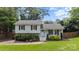 Beautiful home exterior with light blue door, green grass, and professional landscaping at 2100 Shadyview Dr, Charlotte, NC 28210