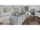 Open kitchen featuring a large center island with dark countertops, hardwood floors, and modern appliances at 2100 Shadyview Dr, Charlotte, NC 28210