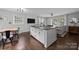 Open-concept kitchen and living area with hardwood floors, a large island, and plenty of natural light at 2100 Shadyview Dr, Charlotte, NC 28210