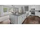 Open kitchen featuring a large center island with dark countertops, hardwood floors, and modern appliances at 2100 Shadyview Dr, Charlotte, NC 28210