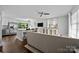 Bright open-concept living space with hardwood floors, comfortable seating, and a stylish kitchen island at 2100 Shadyview Dr, Charlotte, NC 28210