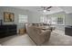 Spacious living room with comfortable sofa and a ceiling fan, providing a cozy atmosphere at 2100 Shadyview Dr, Charlotte, NC 28210
