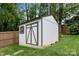 Backyard featuring a shed with a dark trim and ample storage space, with a lush green lawn at 2100 Shadyview Dr, Charlotte, NC 28210