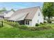 Rear exterior view features a back patio, well-kept lawn, and privacy hedge, enhancing the property's outdoor appeal at 2478 23Rd Ne St, Hickory, NC 28601