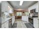 Well-lit kitchen with white cabinetry, stainless appliances, and eat-in breakfast area at 2478 23Rd Ne St, Hickory, NC 28601