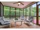 Enclosed sunroom with tiled floor, ceiling fan, and view of greenery at 2478 23Rd Ne St, Hickory, NC 28601