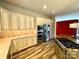 Custom kitchen features stainless steel appliances, island cooktop, tile backsplash and sleek wood floors at 255 Charlotte Ann Ln, Hickory, NC 28601