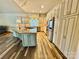 Spacious kitchen with stainless steel appliances, custom cabinetry, island with cooktop, and wood floors at 255 Charlotte Ann Ln, Hickory, NC 28601