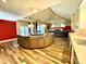 Open-concept space with kitchen island, hardwood flooring, and vaulted ceiling leading to the living room at 255 Charlotte Ann Ln, Hickory, NC 28601