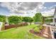 Picturesque backyard with lush green grass, trees, and a stone pathway at 2810 Berry Creek Rd, Charlotte, NC 28214