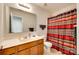 Well-lit bathroom with a large mirror, vanity, toilet, and shower with a curtain at 2810 Berry Creek Rd, Charlotte, NC 28214