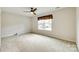 Neutral bedroom with carpet, a ceiling fan, and a window with curtains at 2810 Berry Creek Rd, Charlotte, NC 28214