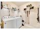 Functional laundry room with washer, dryer, and storage shelves at 2810 Berry Creek Rd, Charlotte, NC 28214