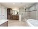 Elegant bathroom featuring a large soaking tub, separate shower, and dual vanities with granite countertops at 3925 Tokay Ln, Fort Mill, SC 29707