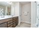 Well-lit bathroom featuring a double sink vanity, large mirror, and neutral colors for a serene atmosphere at 3925 Tokay Ln, Fort Mill, SC 29707