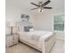 Relaxing bedroom with light wood furniture, a ceiling fan, and a large window offering a serene view at 3925 Tokay Ln, Fort Mill, SC 29707