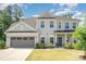 Charming two-story home with a gray exterior, two-car garage, landscaped yard, and inviting front porch at 3925 Tokay Ln, Fort Mill, SC 29707