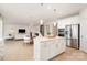 Bright, open kitchen with island, stainless steel appliances, and seamless flow to the living area at 3925 Tokay Ln, Fort Mill, SC 29707