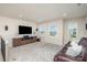 Cozy living room with plush seating, a large TV, and ample natural light from the windows at 3925 Tokay Ln, Fort Mill, SC 29707