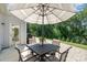 Outdoor patio with a dining set under an umbrella, offering a relaxing space for dining and entertaining at 3925 Tokay Ln, Fort Mill, SC 29707