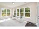 Bright sunroom features large windows, neutral paint, and stylish seating, perfect for relaxation and enjoying the view at 3925 Tokay Ln, Fort Mill, SC 29707
