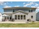 A beautiful two-story home back exterior, featuring a large patio and well-maintained lawn at 3925 Tokay Ln, Indian Land, SC 29707