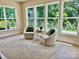 Bright sitting area featuring neutral chairs, stylish rug, and natural light from large windows overlooking greenery at 3925 Tokay Ln, Indian Land, SC 29707