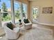 Bright sitting area featuring neutral chairs, stylish rug, and natural light from large windows and access to outside at 3925 Tokay Ln, Indian Land, SC 29707