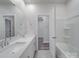 Bright bathroom features double sinks with a quartz countertop and tile flooring at 4142 Longmore Ln, Kannapolis, NC 28081