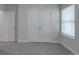 Neutral bedroom with carpet, closet doors, and a window at 4142 Longmore Ln, Kannapolis, NC 28081