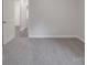 Neutral bedroom with carpet flooring and view to bathroom with gray flooring at 4142 Longmore Ln, Kannapolis, NC 28081