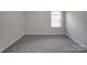 Well-lit bedroom features soft carpet and a bright window at 4142 Longmore Ln, Kannapolis, NC 28081