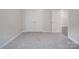 Empty carpeted room with neutral walls, closet, and view to bathroom at 4142 Longmore Ln, Kannapolis, NC 28081