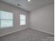 Cozy bedroom with plush carpet flooring and bright natural light from two large windows at 4142 Longmore Ln, Kannapolis, NC 28081