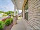 Beautiful front porch with brick columns and a charming view of the neighborhood at 4142 Longmore Ln, Kannapolis, NC 28081
