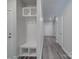 Hallway with light gray wood floors, white doors, and mudroom lockers at 4142 Longmore Ln, Kannapolis, NC 28081