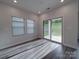 Bright and airy living room with sliding glass doors to the backyard and two windows at 4142 Longmore Ln, Kannapolis, NC 28081