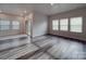 Spacious and well-lit living area with multiple windows, sliding doors and wood-look floors at 4142 Longmore Ln, Kannapolis, NC 28081