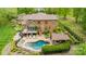 Aerial view showcasing the home's backyard oasis with a pool, outdoor kitchen, and manicured landscaping at 4600 Spicewood Dr, Charlotte, NC 28227