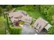 Sprawling estate with manicured lawn, featuring a brick home and detached garage, surrounded by mature trees at 4600 Spicewood Dr, Charlotte, NC 28227
