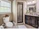 Bathroom featuring a tiled shower with glass door, toilet, and granite countertop vanity at 4600 Spicewood Dr, Charlotte, NC 28227