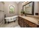 Bathroom featuring soaking tub, marble countertop, and dark wood cabinets at 4600 Spicewood Dr, Charlotte, NC 28227