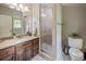 Neutral bathroom with vanity and tiled walk-in shower at 4600 Spicewood Dr, Charlotte, NC 28227