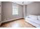 Neutral bedroom featuring hardwood floors, large window, and a comfortable white sofa at 4600 Spicewood Dr, Charlotte, NC 28227