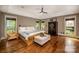 Spacious main bedroom featuring natural light, ceiling fan, and hardwood floors at 4600 Spicewood Dr, Charlotte, NC 28227