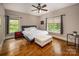 Comfortable bedroom with hardwood floors, natural light, and ceiling fan at 4600 Spicewood Dr, Charlotte, NC 28227