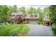 A stately brick home boasts a lush, landscaped yard, a convenient two-car garage, and a charming covered carport at 4600 Spicewood Dr, Charlotte, NC 28227