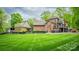Beautiful brick home with lush landscaping, a fenced yard, and an attached garage at 4600 Spicewood Dr, Charlotte, NC 28227