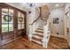 Stunning entryway with hardwood floors, wood double doors and staircase at 4600 Spicewood Dr, Charlotte, NC 28227