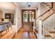Foyer featuring hardwood floors, a wooden front door with wreath, and a staircase at 4600 Spicewood Dr, Charlotte, NC 28227